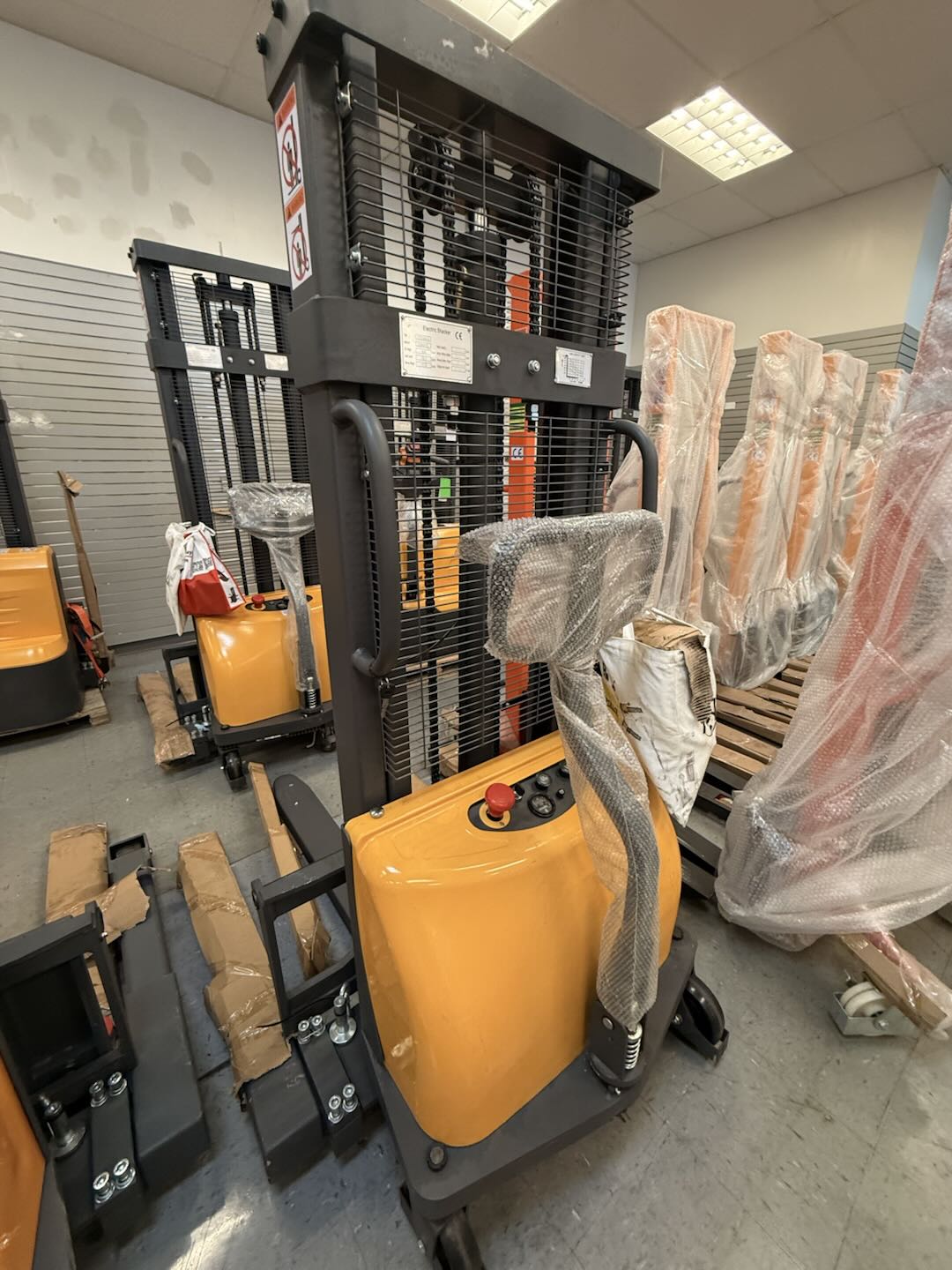 Pre-owned Premium Used CTD10B-III-98–2,200 lb Semi-Electric Stacker, 98" Lift, Straddle Legs & Adjustable Forks-21060112